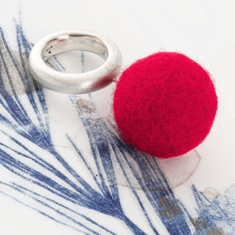 Side view of The Steppe red ring showing 925 silver band and felt detail