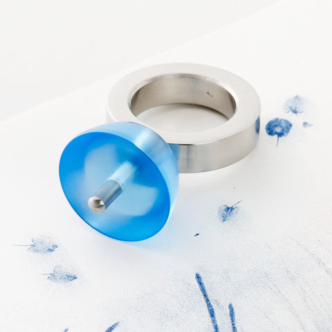 Side view of Koma Blue ring displaying Japanese sugurigoma spinning top design