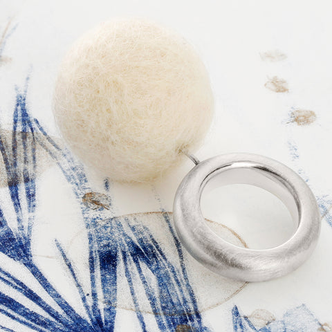Side view of The Steppe beige ring showing 925 silver band and felt detail
